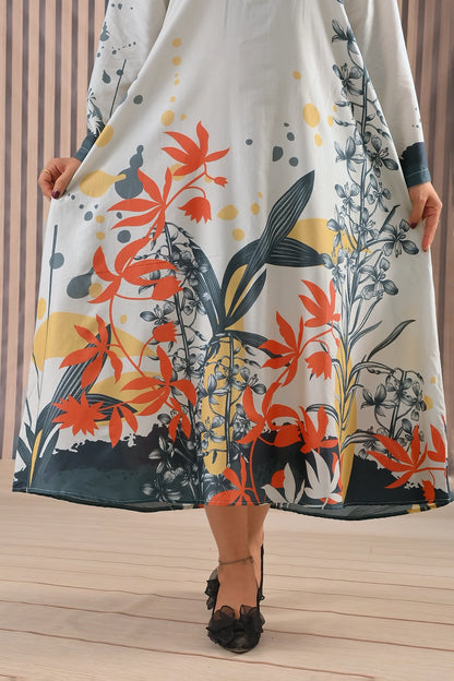 Close-up of BOLDSTEP floral printed maxi dress highlighting vivid orange, yellow, and blue floral motifs near the hem on ivory cotton fabric | BOLD STEP | BOLDSTEP.PK | BOLDSTEP STORE.