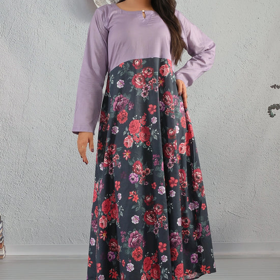 BOLDSTEP product video showcasing a lavender and black floral printed cotton maxi dress with red and purple rose patterns. The model walks and poses to highlight the full flowy silhouette, soft cotton texture, and elegant neckline design. Perfect blend of comfort and charm from BOLD STEP | BOLDSTEP.PK | BOLDSTEP STORE.