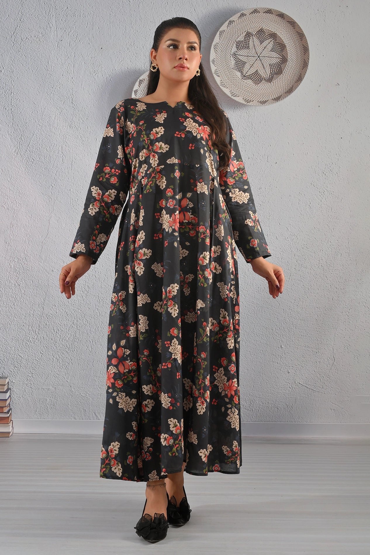 BOLDSTEP product video featuring a black floral printed cotton maxi dress with beige and red flower patterns. The model showcases the soft flare, long sleeves, and elegant fall of the dress in natural studio lighting — a timeless floral design from BOLD STEP | BOLDSTEP.PK | BOLDSTEP STORE.