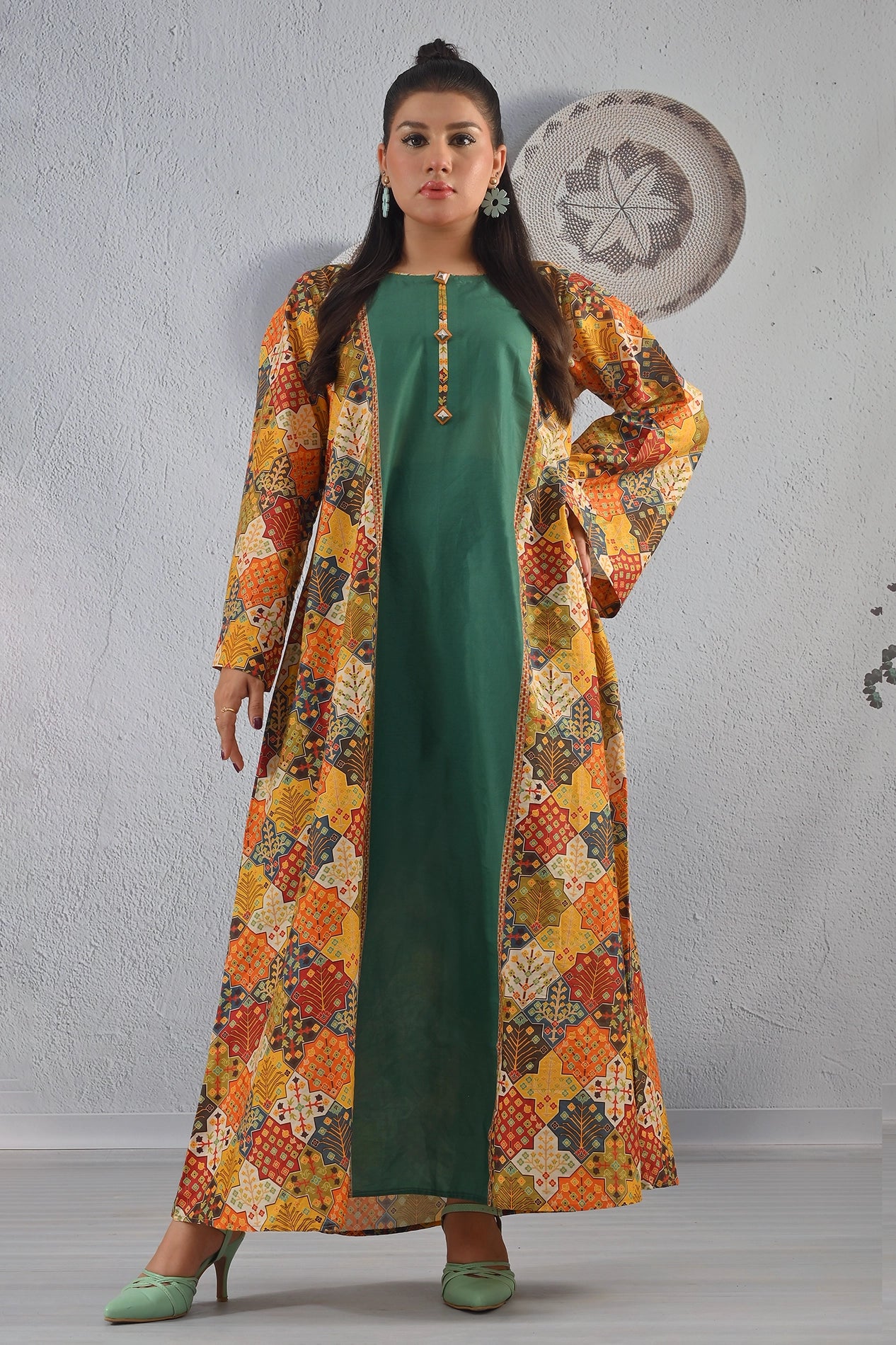 BOLDSTEP product video showcasing a long ethnic-print cotton maxi dress with a solid green inner and colorful multi-pattern outer jacket. The model walks and poses gracefully, highlighting the detailed prints, flowy fabric, and statement neckline — a premium handcrafted outfit from BOLD STEP | BOLDSTEP.PK | BOLDSTEP STORE.