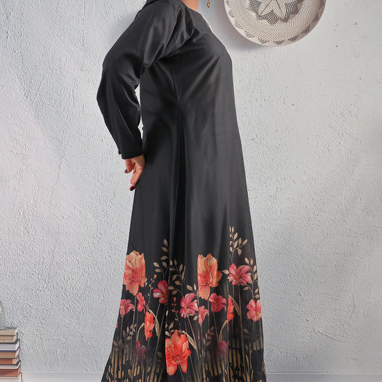 BOLDSTEP product video showcasing an elegant black cotton maxi dress with red and peach floral border print. The model walks and poses gracefully to highlight the long flowy silhouette, full sleeves, and soft fabric texture – premium floral fashion by BOLD STEP | BOLDSTEP.PK | BOLDSTEP STORE.