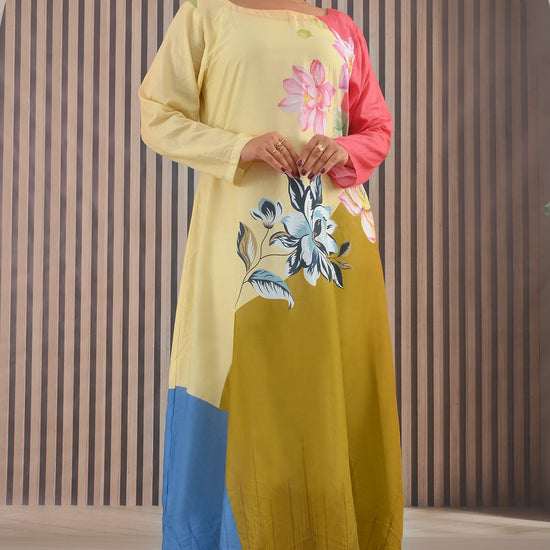 BOLDSTEP product video showcasing a pastel yellow, coral pink, mustard, and blue color-block cotton maxi dress with floral prints. The model gracefully walks and poses, highlighting the flowy silhouette, long sleeves, and artistic floral details – elegant summer wear from BOLD STEP | BOLDSTEP.PK | BOLDSTEP STORE.