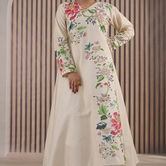 BOLDSTEP product video showcasing an elegant cream cotton maxi dress with multicolor floral prints. The model walks and poses gracefully, highlighting the flowy silhouette, long sleeves, and intricate floral details on the front and sleeves — premium stitched outfit from BOLD STEP | BOLDSTEP.PK | BOLDSTEP STORE.