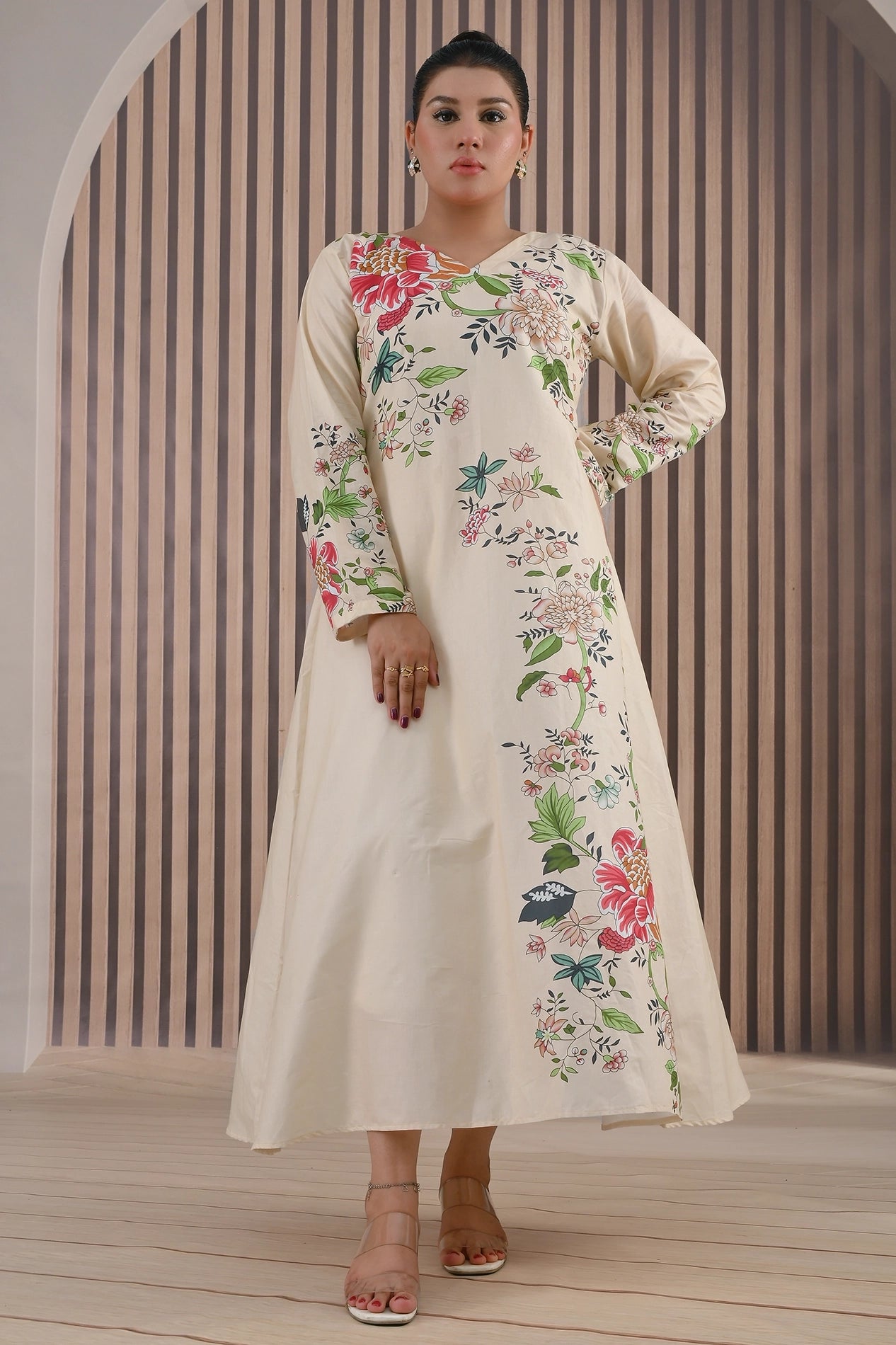 BOLDSTEP product video showcasing an elegant cream cotton maxi dress with multicolor floral prints. The model walks and poses gracefully, highlighting the flowy silhouette, long sleeves, and intricate floral details on the front and sleeves — premium stitched outfit from BOLD STEP | BOLDSTEP.PK | BOLDSTEP STORE.